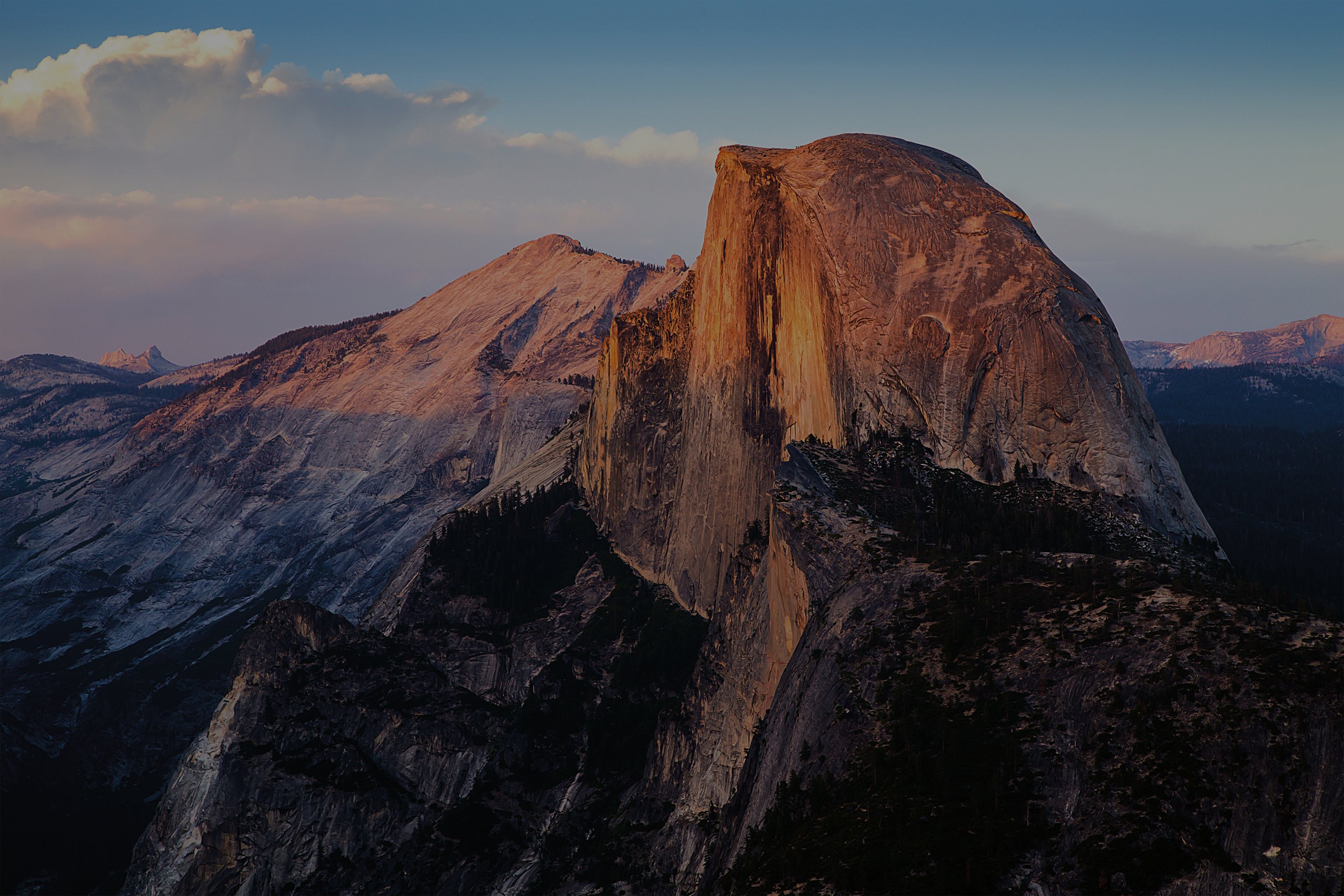 A vibrant sunset illuminates Half Dome in Yosemite National Park.