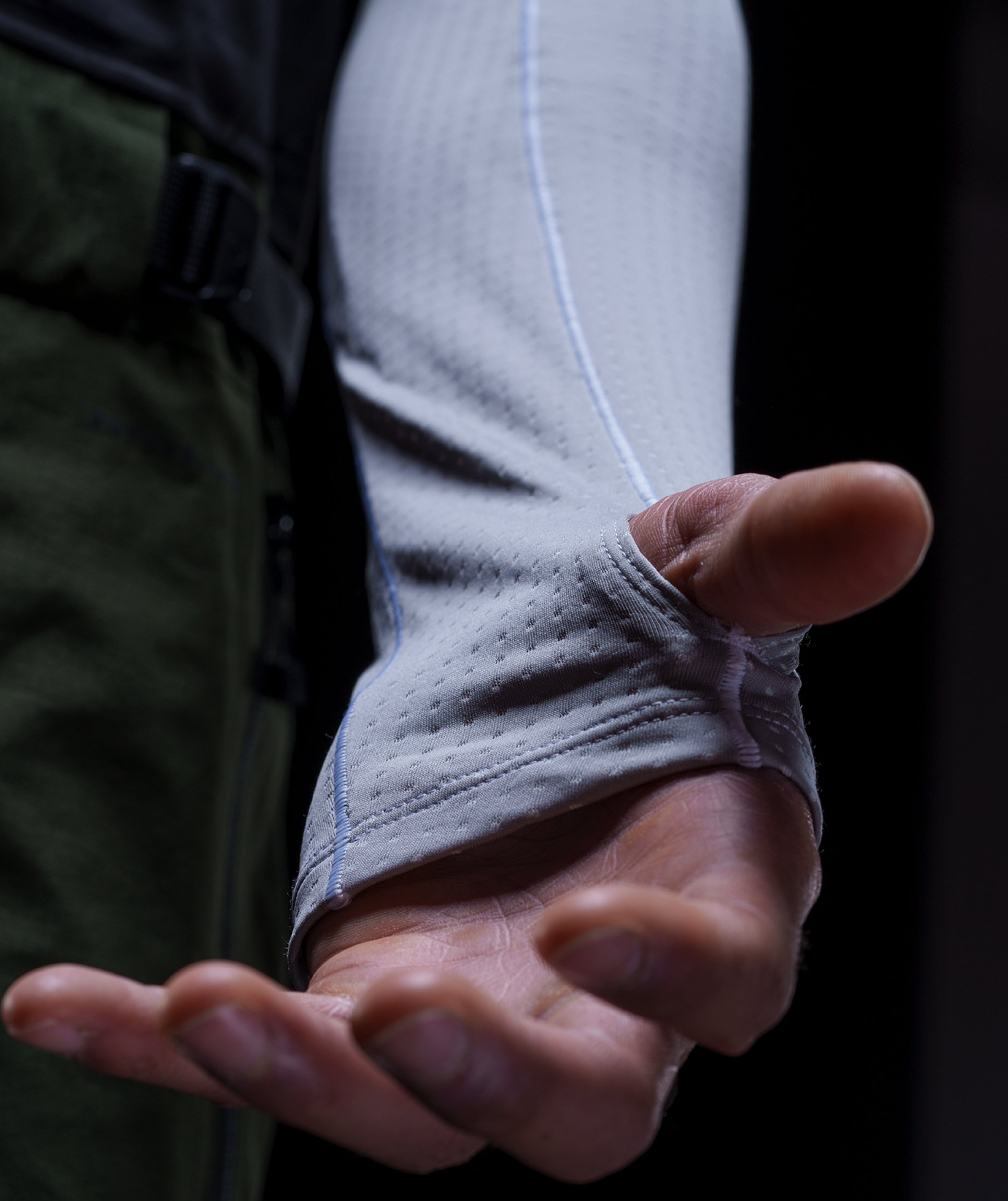 A person wears the DotKnit Crew. A crew with a unique texture and design, that even fits around your hands to maximize warmth.