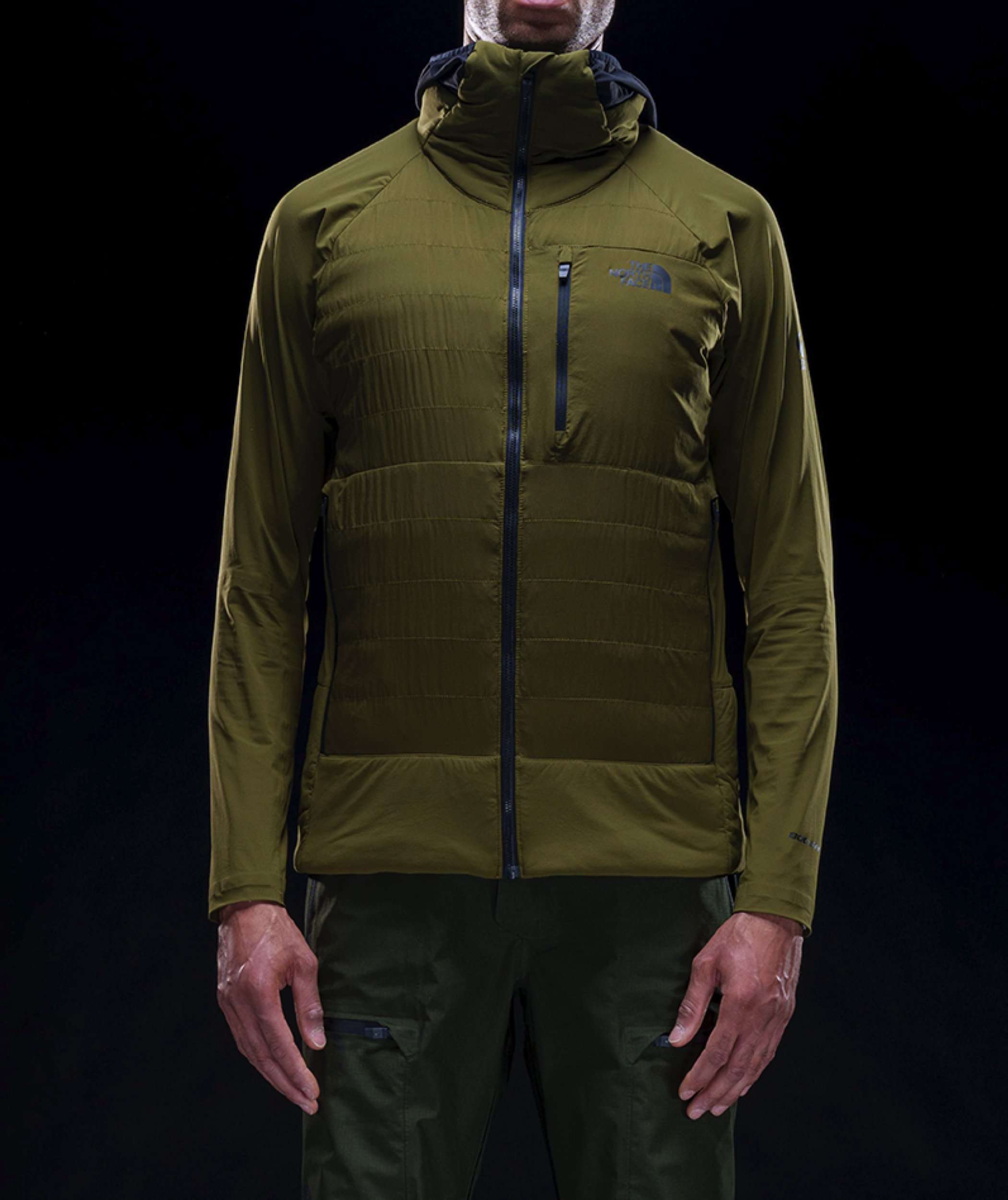 A person wears the Steep 50/50 Down Jacket. A jacket with layers of warmth, including a more ergonomically-designed hood.