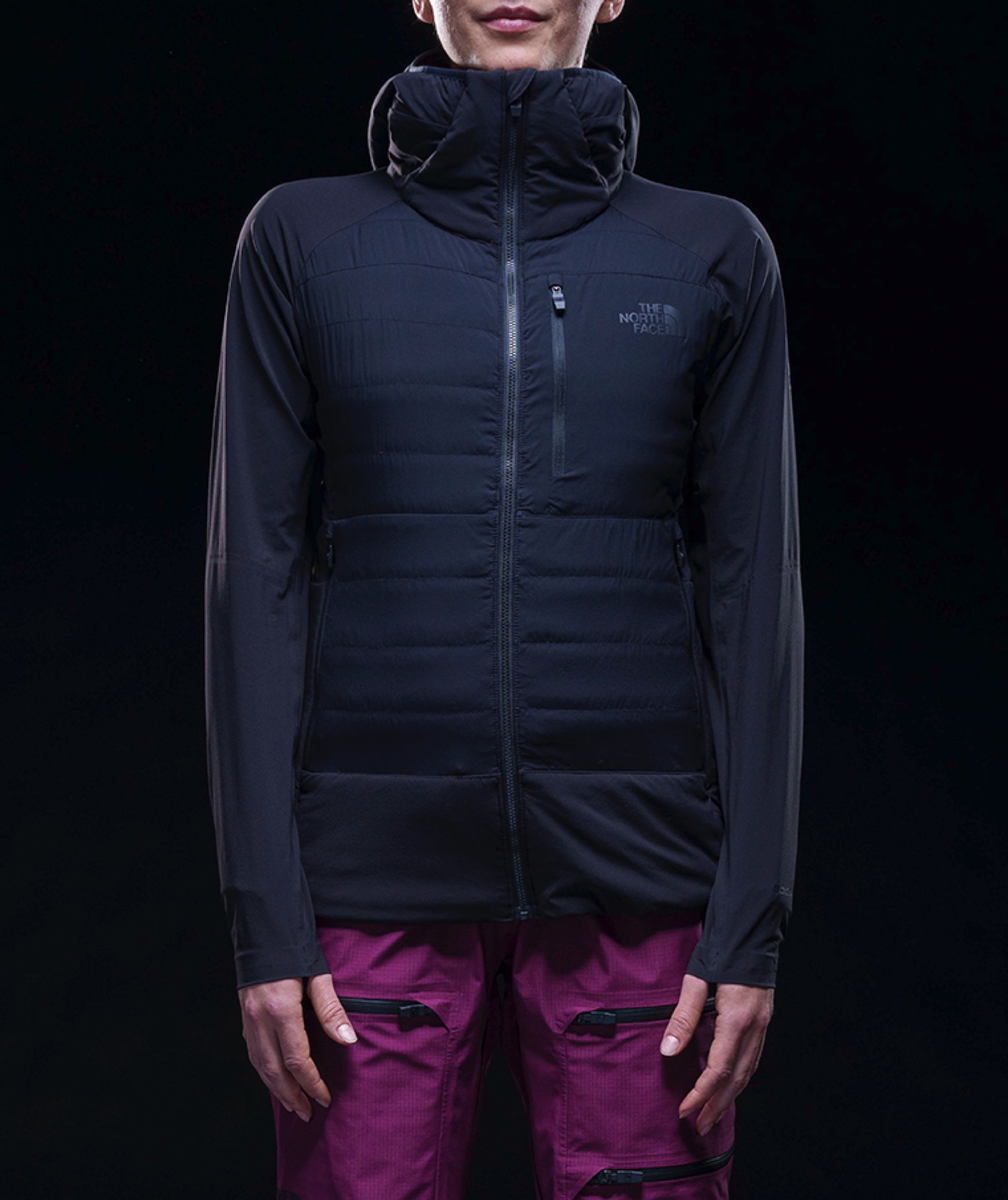 A person wears the Steep 50/50 Down Jacket. A jacket with layers of warmth, including a more ergonomically-designed hood.