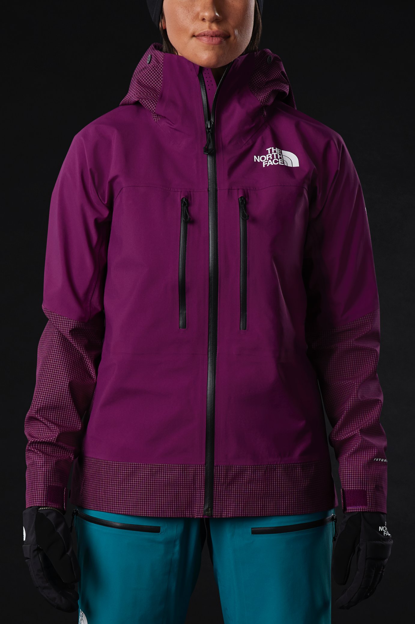 A person wears the Summit L5 FUTURELIGHT Jacket. A jacket with a classic silhouette and many features, like two large front zippered pockets.