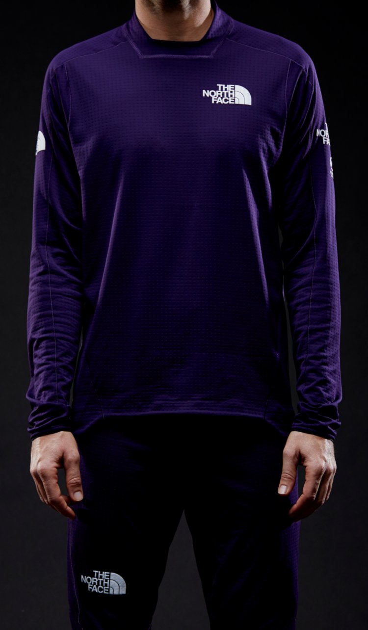 A neck-to-torso shot of a male athlete wearing a garment featuring DotKnit technology.