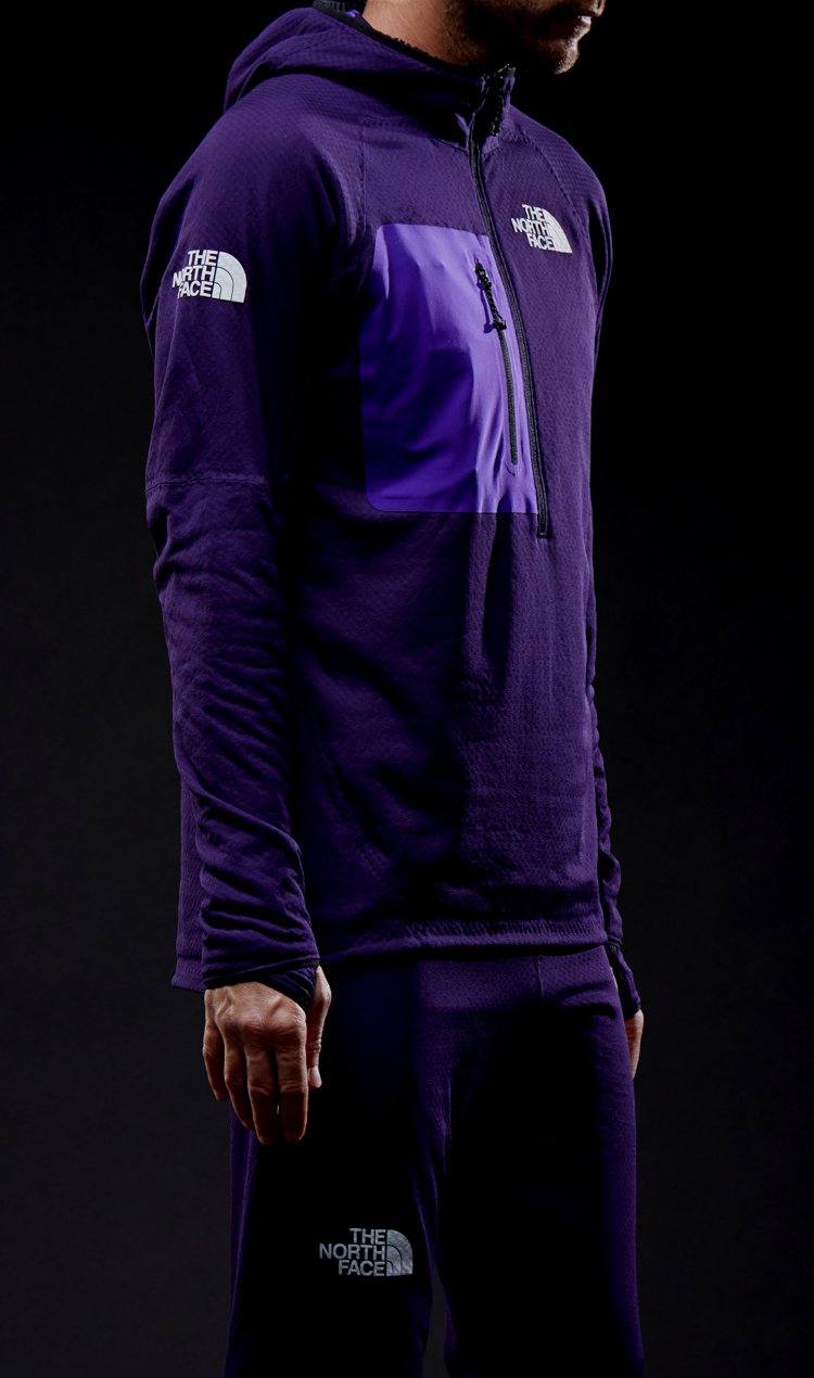 A neck-to-torso shot of a male athlete wearing a garment featuring FUTUREFLEECE™ technology.