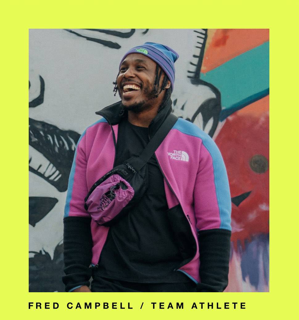 Team athlete Fred stands by a mural in The North Face gear.
