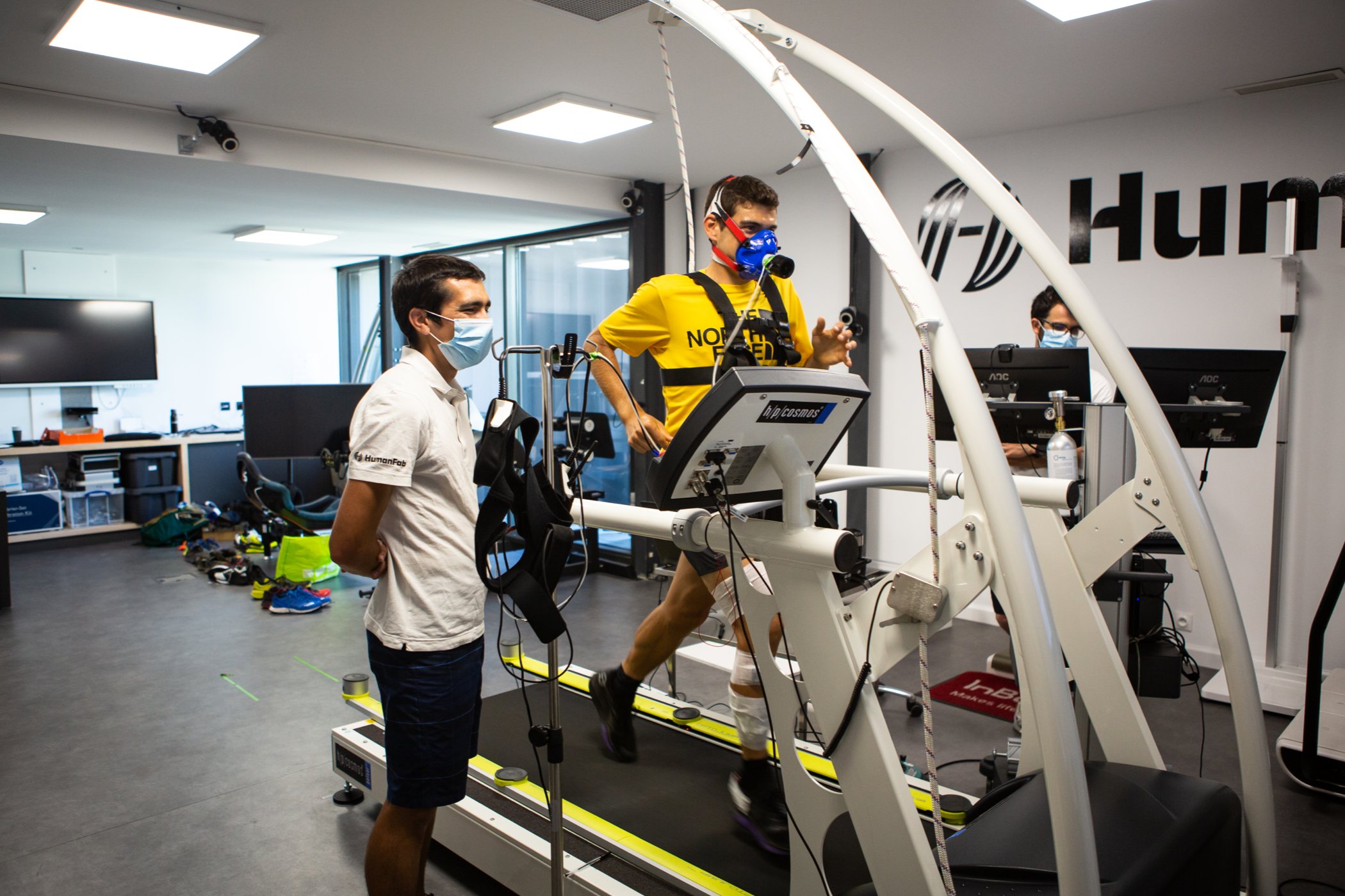 An athlete for The North Face is hooked up to an array of testing equipment as he runs on a treadmill in a lab.